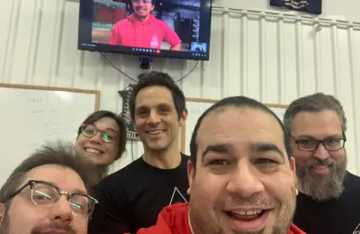 Group of people smiling together in a martial arts setting