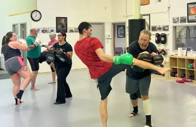 Group of students practicing kicks in class