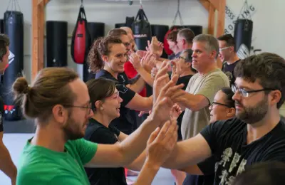 Group of students practicing wrist techniques in martial arts class