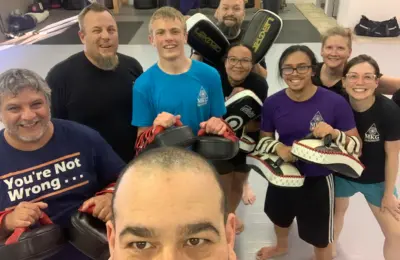 Group of martial arts students standing together and smiling
