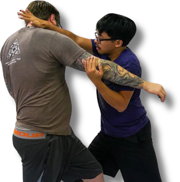 Student practicing close-range clinch technique in martial arts class